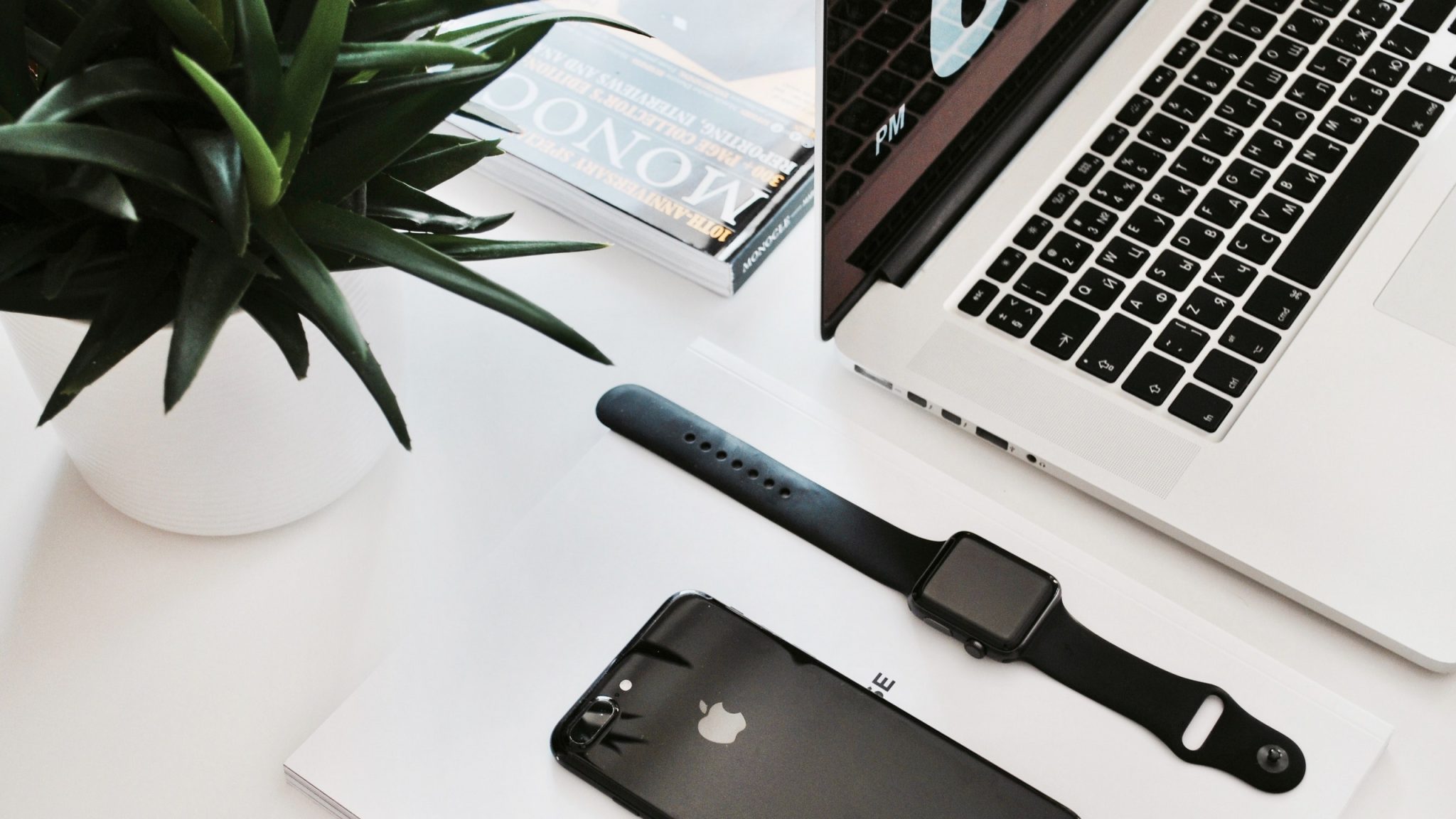 207101 an apple watch and an iphone on a desk next to a l
